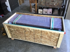 open crate with bubble wrapped bench