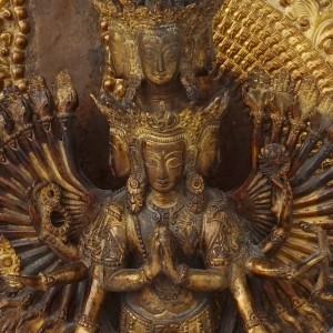 facial detail of vintage padmapani avalokiteshvara of copper and gold dust